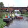 The plucky volunteers of the City Council\'s MB \'Greenlife\', tear away at the pernicious pennywort weed above Echo Bridge. by roger hutchinson – October 2003